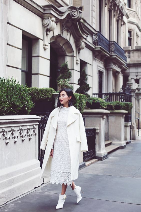 all-white outfit with a lace midi dress, ankle booties and a warm coat for a bride-to-be