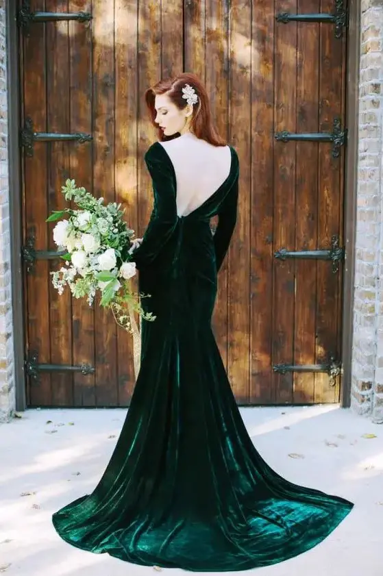 an emerald velvet wedding dress with a low back and copper hair to leave an impression
