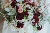 an ethereal winter wedding bouquet with marsala blooms, blush roses, pale greenery, twigs and some white blooms