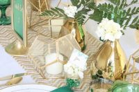 emerald glasses, napkins, table numbers and gold vases, chevron table runners and candle holders for a bold look