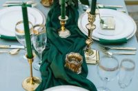 emerald napkins and a table runner, emerald candles in gold candle holders and gold cutlery and gold rim glasses