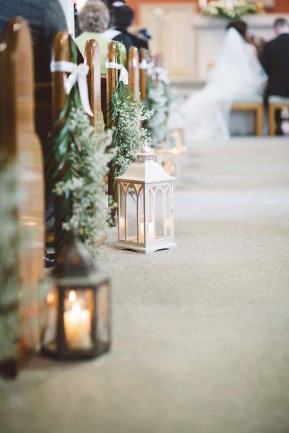 evergreen and baby's breath posies and candle lanterns will give your wedding aisle a winter wonderland feel