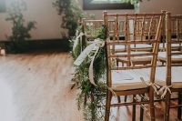 evergreens with a white ribbon bow are nice posies to accent the chairs of your wedding aisle