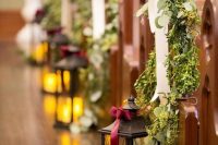 greenery and a white ribbon bow, a large candle lantern are ultimate to make your winer wedding aisle cozy and chic