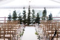 greenery, floating candles in tall vases help to create a winter wonderland feel in the ceremony space