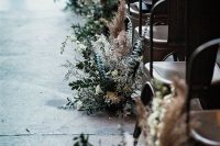 greenery, pampas grass and white blooms are very textural and chic arrangements to highlight your wedding aisle at its best