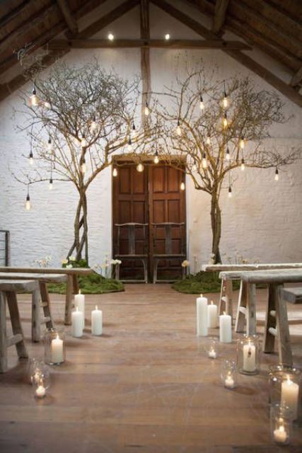 pillar candles on the floor and in glass candleholders make the wedding ceremony space wonderland like and very romantic