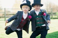 ring bearers wearing jeans, grey blazers and bright tartan waistcoats and hats for a bold and cool look