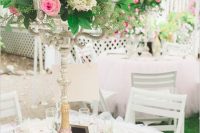 a beautiful Valentine’s Day wedding table with a pink glitter vase, a tall floral arrangement, jars with hearts and white porcelain