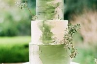a beautiful botanical wedding cake with green watercolors and fresh greenery is a lovely idea for a spring or summer wedding