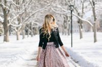a black top with an embellished neckline, a matching jacket, a rose gold sequin midi skirt, black shoes