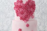 a blush wedding cake decorated with pink and light pink cream blooms looks very romantic and very chic