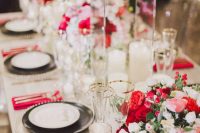 a bright Valentine’s Day wedding table with fuchsia napkins and blooms, gold rimmed glasses and gold cutlery, candles is wow