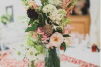 a bright floral table runner and pretty neutral and pastel blooms are a great combo for a bright spring or summer wedding