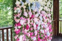 a bright floral wall in white, pink and pink plus textural greenery as a ceremony and photo booth wedding backdrop