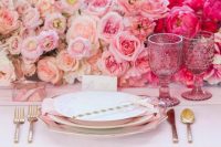 a bright ombre Valentine’s Day wedding table with blush to fuchsia floral runner, gold rimmed plates and gold cutlery and pink glasses