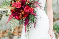 a colorful and bold Valentine wedding bouquet of burgundy, red and fuchsia blooms and greenery is a lovely idea