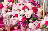 a colorful floral centerpiece of light pink, fuchsia and purple blooms and greenery is a beautiful and bold idea for Valentine’s Day