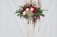 a gorgeous Valentine wedding bouquet of white, red and deep purple blooms and foliage is a bold statement
