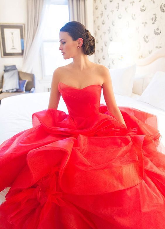 a gorgeous fiery red wedding ballgown with a strapless draped bodice, a layered skirt and a train is a beautiful color statement