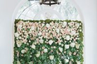 a greenery and flower wall with white hydrangeas and blush roses for a romantic feel