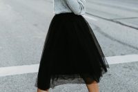 a grey off the shoulder sweater, a black tulle skirt, black block heels for a girlish feel