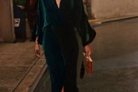 a hunter green midi dress with a pencil skirt, wide sleeves and a plunging neckline, embellished shoes, a mustard clutch and statement earrings