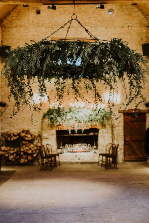 a large cascading greenery chandelier with LEDs can highlight a dance floor or a reception