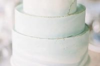 a light green wedding cake with a textural gold leaf egde is a very soft and tender idea