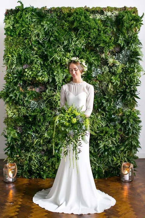 a living wall backdrop and a matching bridal bouquet to bring an outdoor feel indoors