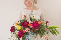 a lush and bold Valentine’s Day wedding bouquet of light pink, fuchsia, orange, yellow blooms and leaves