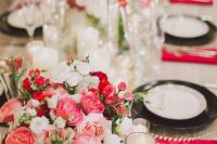 a lush floral centerpiece of blush, white, red blooms and greenery is a beautiful idea for a Valentine wedding