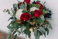 a luxurious red and white rose wedding bouquet with greenery and ferns and some gilded leaves is pure love for a Valentine’s Day bride