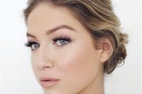 a natural wedding makeup with a shiny pink lip, pink eyeshadow, faux eyelashes for an accent and a touch of blush