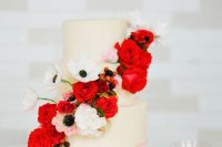 a neutral wedding cake with white and red blooms and berries is a traditionally cool idea for a Valentine wedding