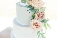a powder blue wedding cake with gold leaf decor and blush roses and thistles is a very elegant choice