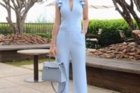 a powder blus jumpsuit with ruffled detailing on the shoulders is a chic spring-like idea