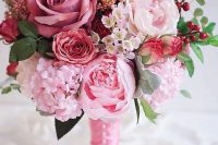 a pretty and sweet Valentine wedding bouquet of red, pink and blush blooms, berries and leaves is amazing for your wedding