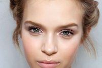 a pretty wedding makeup with a shiny blush lip, a touch of blush, a bit of tan eyeshadow, accented eyebrows is fresh