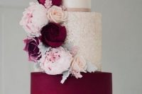 a refined white, gold glitter, purple wedding cake with matching blooms in purple and blush is very chic and stylish