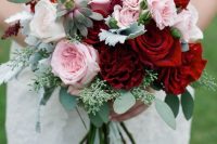 a romantic and chic Valentine wedding bouquet with deep red roses, pink and blue ones plus succulents and eucalyptus
