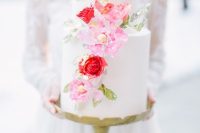 a romantic white wedding cake decorated with pink and red blooms and greenery is a gorgeous idea