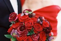a stunning red and burgundy rose wedding bouquet with leaves is a pretty statement with color to rock at a Valentine wedding
