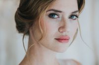a super fresh and bold wedding makeup with a bright pink lip, a touch of blush, accented eyes with mascara and eyeliner, beautiful skin tone