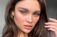 a super trendy wedidng makeup with an accent on the dewy skin, with a pink lip, pink cheeks, statement eyebrows and a bit of eyeliner