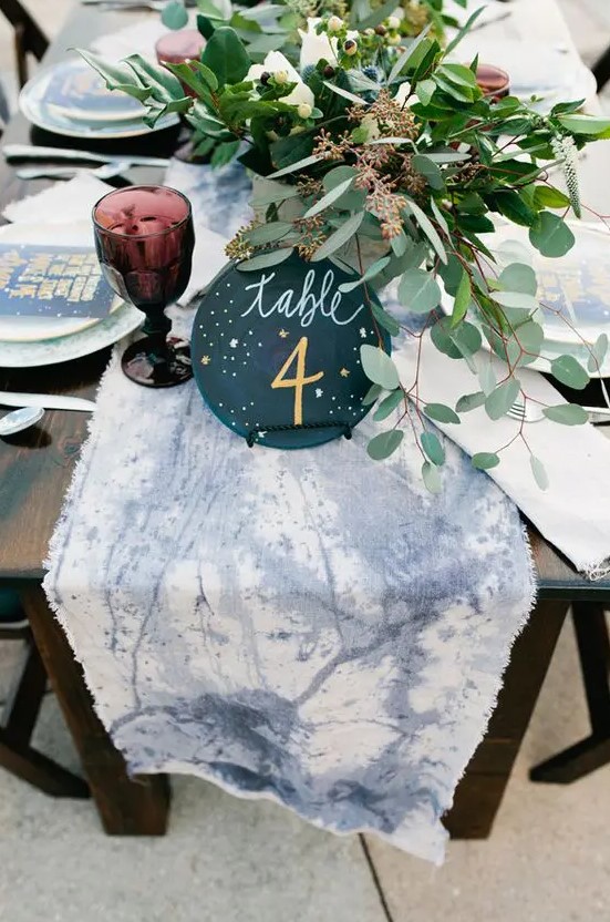 a watercolor dyed constellation table runner and a table number are a great idea for a constellation or celestial wedding