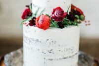 a white wedding cake decorated with red, burgundy and deep purpel blooms is an elegant and chic Valentine idea
