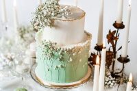 an ethereal white and green wedding cake topped with baby’s breath and sugar baby’s breath for a romantic spring wedding