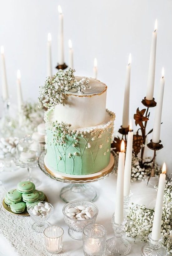 an ethereal white and green wedding cake topped with baby's breath and sugar baby's breath for a romantic spring wedding