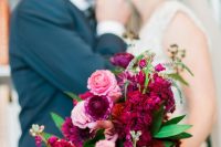 an extra bold pink, light pink, red and fuchsia wedding bouquet with foliage for a Valentine bride